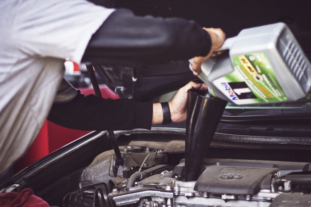 Fresh oil being poured into an open engine bay
