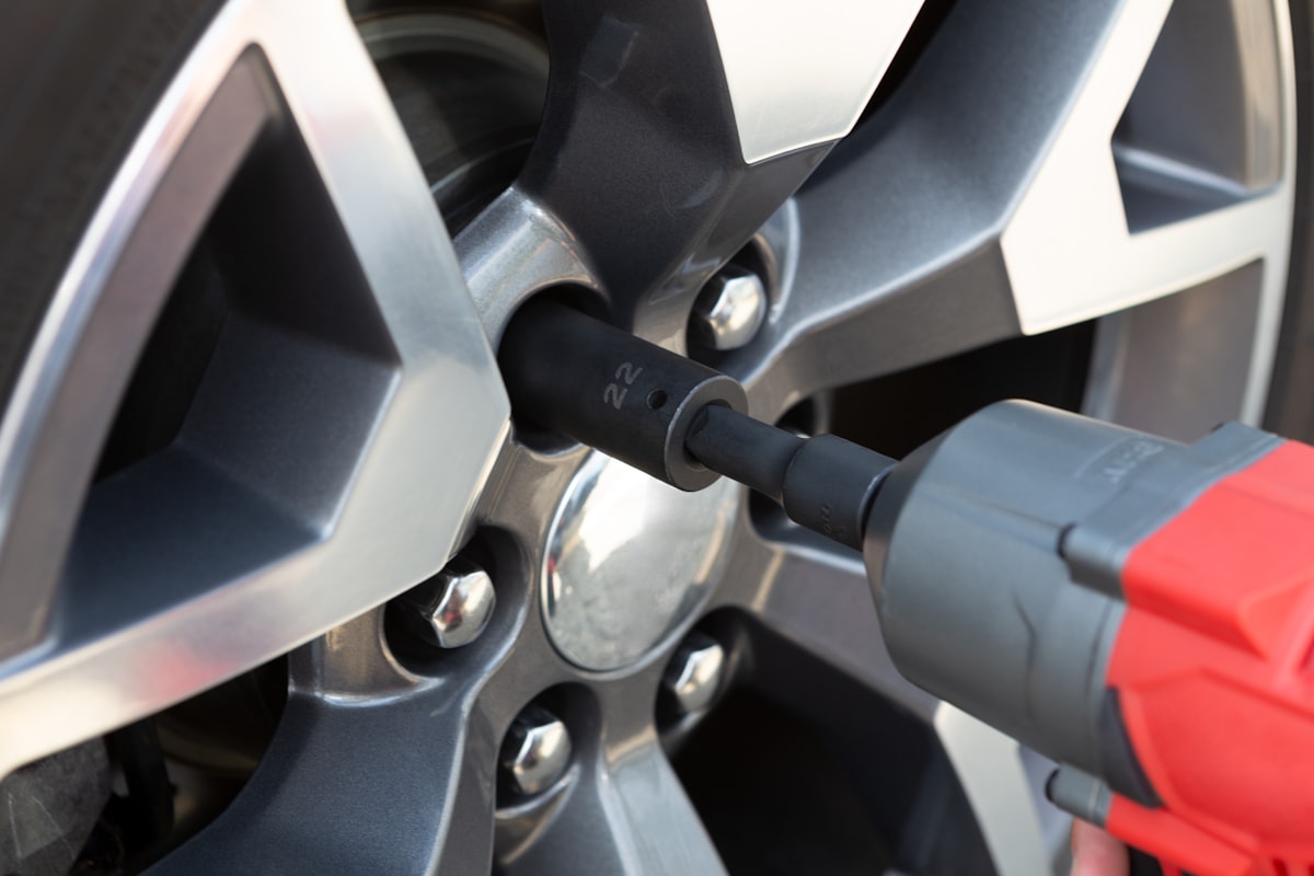 An impact wrench being used on an alloy wheel's lug nuts